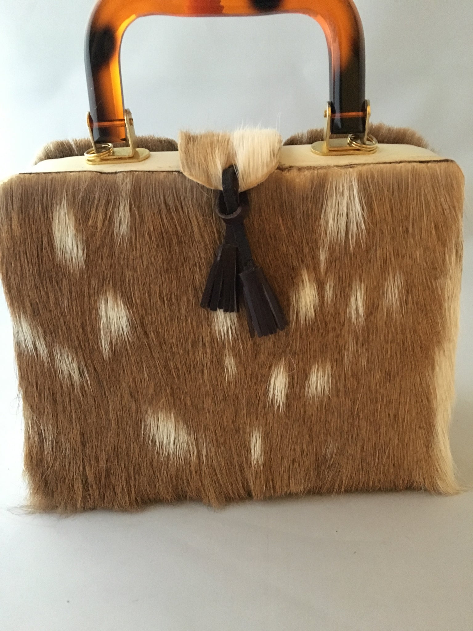 Would that be an Axis??? Square vintage handbag covered in baby deer pelt with an ostrich placket and tortoise buttons. What a combo!  Dimensions - Height 9"; Width 9"; Depth 3"; Handle 4"