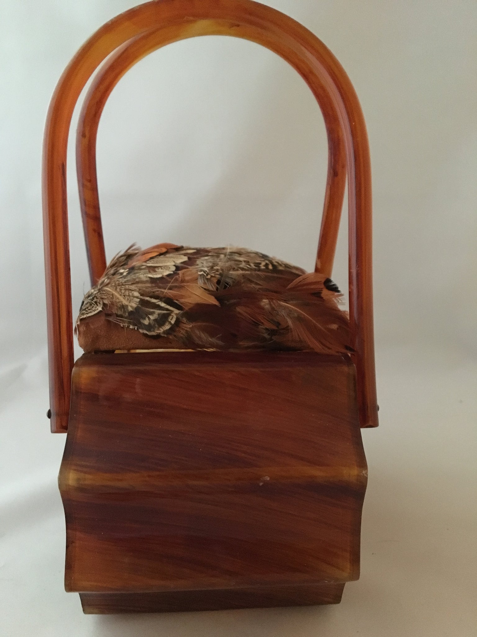 Real pheasant feathers and a hand carved German folk-art pheasant adorn this 1940s vintage Wilardy lucite purse. Its unusual shape makes it a true collector's item. No other in the world is its equal.   Dimensions - Height 8"; Width 8"; Depth 4.5"; Handle 6"