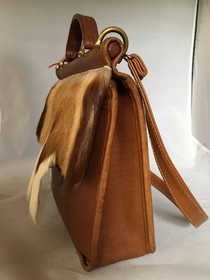 This original 1960's Coach bag has been updated with a silky soft antelope pelt. Your next business meeting will start with oohs and ahs as you take out your notebook and files.  Dimensions - Height 10"; Length 10"; Depth 3"