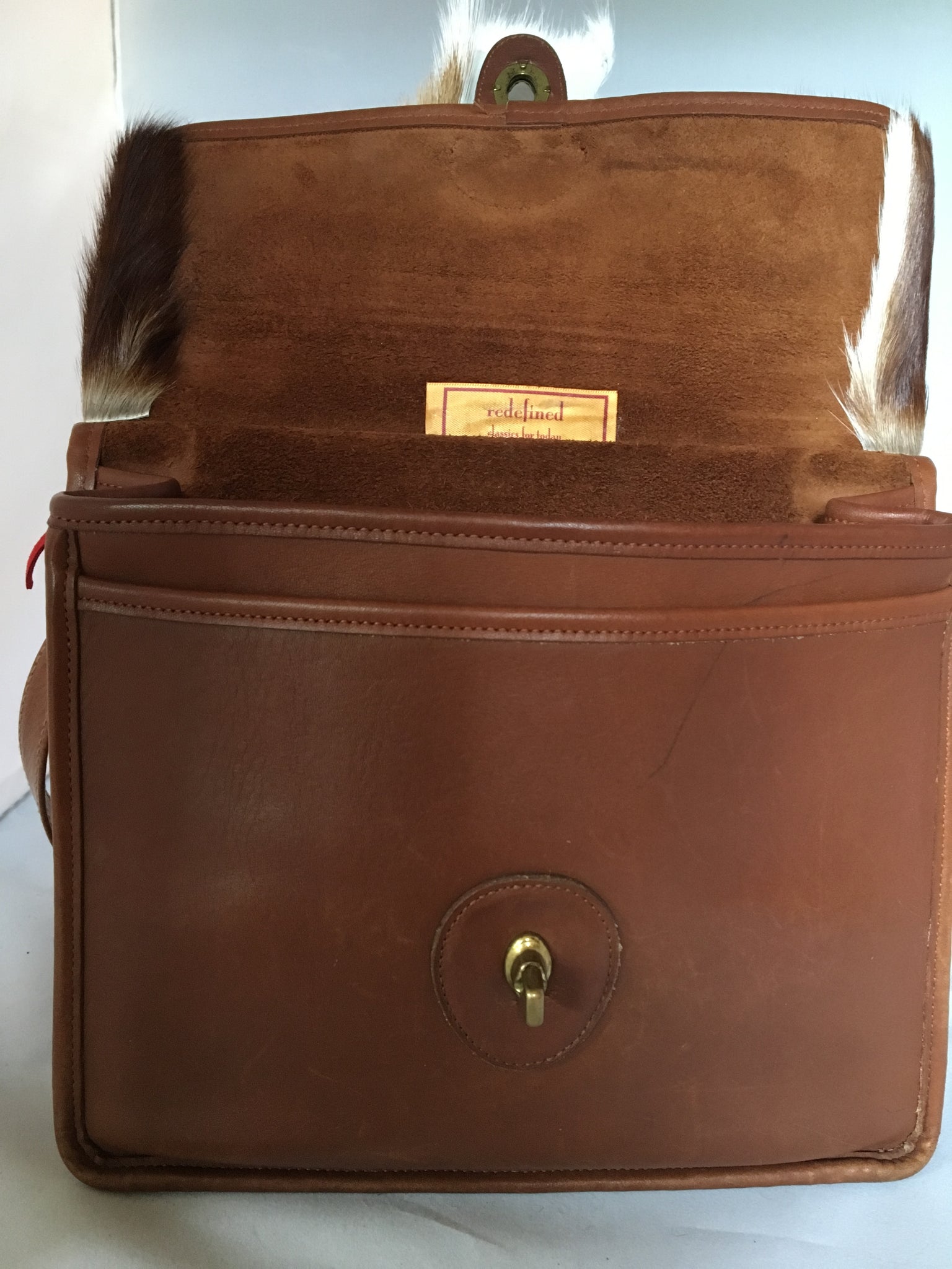 This original 1960's Coach bag has been updated with a silky soft antelope pelt. Your next business meeting will start with oohs and ahs as you take out your notebook and files.  Dimensions - Height 10"; Length 10"; Depth 3"