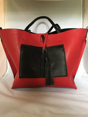 This English tote-style handbag is perfect for the world traveler since it reverses from practical black to fiery red and it even comes wit a matching clutch. How "veddy, veddy" British!   Dimensions - Height 13"; Length 12"; Depth 7"