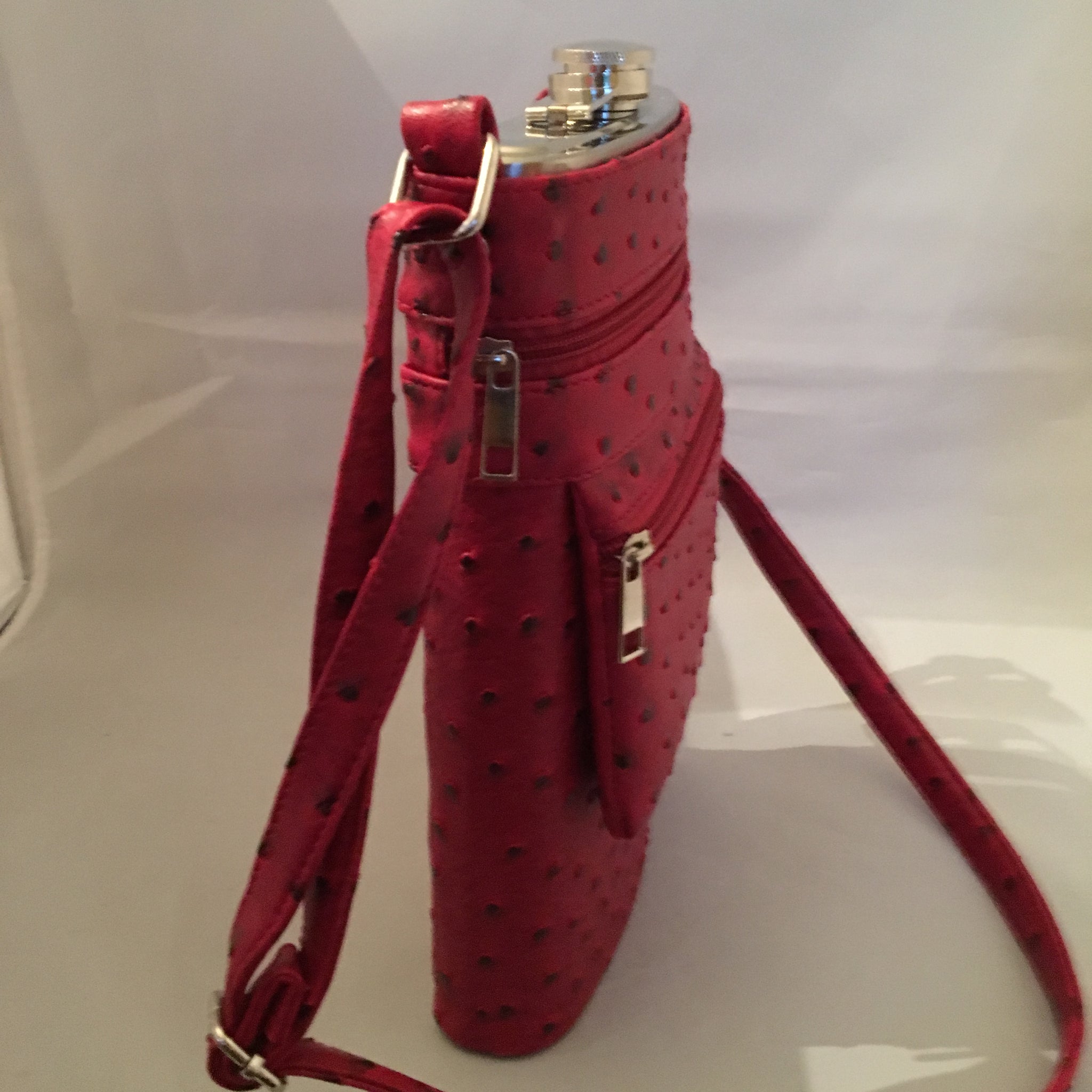 This Ultimate Tailgate Flask discretely holds 2 bottles of wine! It's made of heavy-duty insulated aluminum, comes with its own funnel and sports a shoulder strap. You'll be the hit of the parking lot! Check to see if we have it in your school colors!  Dimensions - Height 12"; Width 7"; Depth 2"