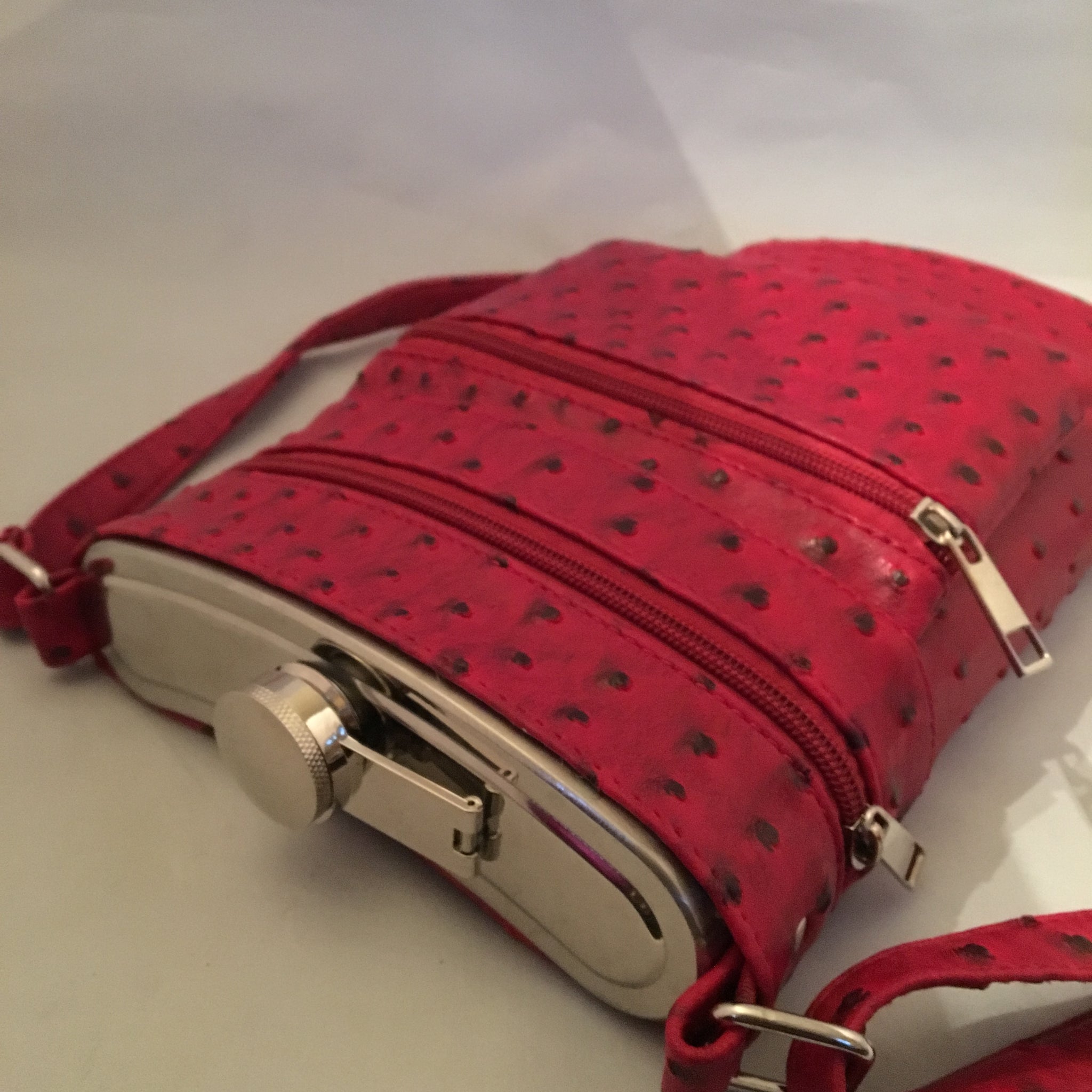 This Ultimate Tailgate Flask discretely holds 2 bottles of wine! It's made of heavy-duty insulated aluminum, comes with its own funnel and sports a shoulder strap. You'll be the hit of the parking lot! Check to see if we have it in your school colors!  Dimensions - Height 12"; Width 7"; Depth 2"