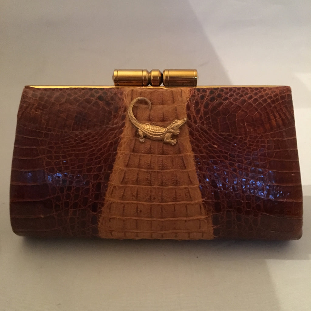 Vintage purse with two tones of caramel in baby crocodile leather, sturdy brass hardware and leather lining. Golden crocodile pendant on front. This baby will only get better as it grows older!  Dimensions - Height 5"; Width 7-1/2"; Depth 2-1/2" 