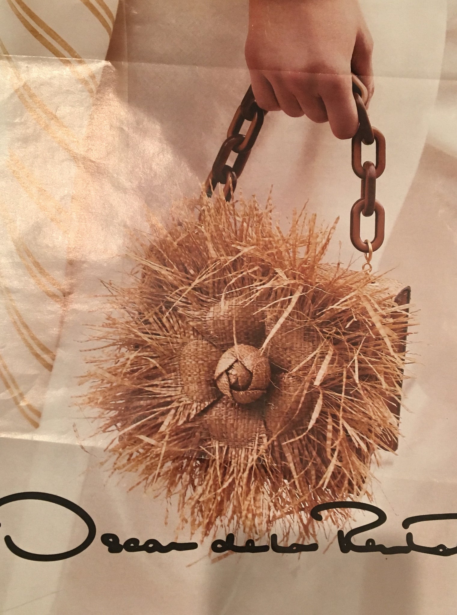 Oscar de la Renta ad that's very similar to our vintage Straw & Raffia Box Bag with tortoise link handle, handmade flower and pristine silk lining? Ours is a 1950's original. His is from the Oscar de la Renta's Spring collection. His is $2000. Ours is a little less.  Dimensions - Height 4.5"; Length 8.25"; Depth 4.25"