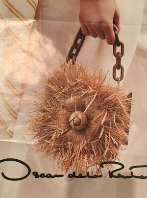 Oscar de la Renta ad that's very similar to our vintage Straw & Raffia Box Bag with tortoise link handle, handmade flower and pristine silk lining? Ours is a 1950's original. His is from the Oscar de la Renta's Spring collection. His is $2000. Ours is a little less.  Dimensions - Height 4.5"; Length 8.25"; Depth 4.25"