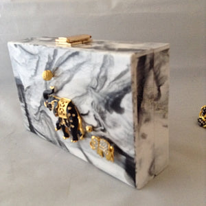 A fabulous box clutch or cross body bag with mama and baby enamel elephants, perfect for lunch to evening - or to a political rally! The hidden chain adds a whimsical touch of fun!
